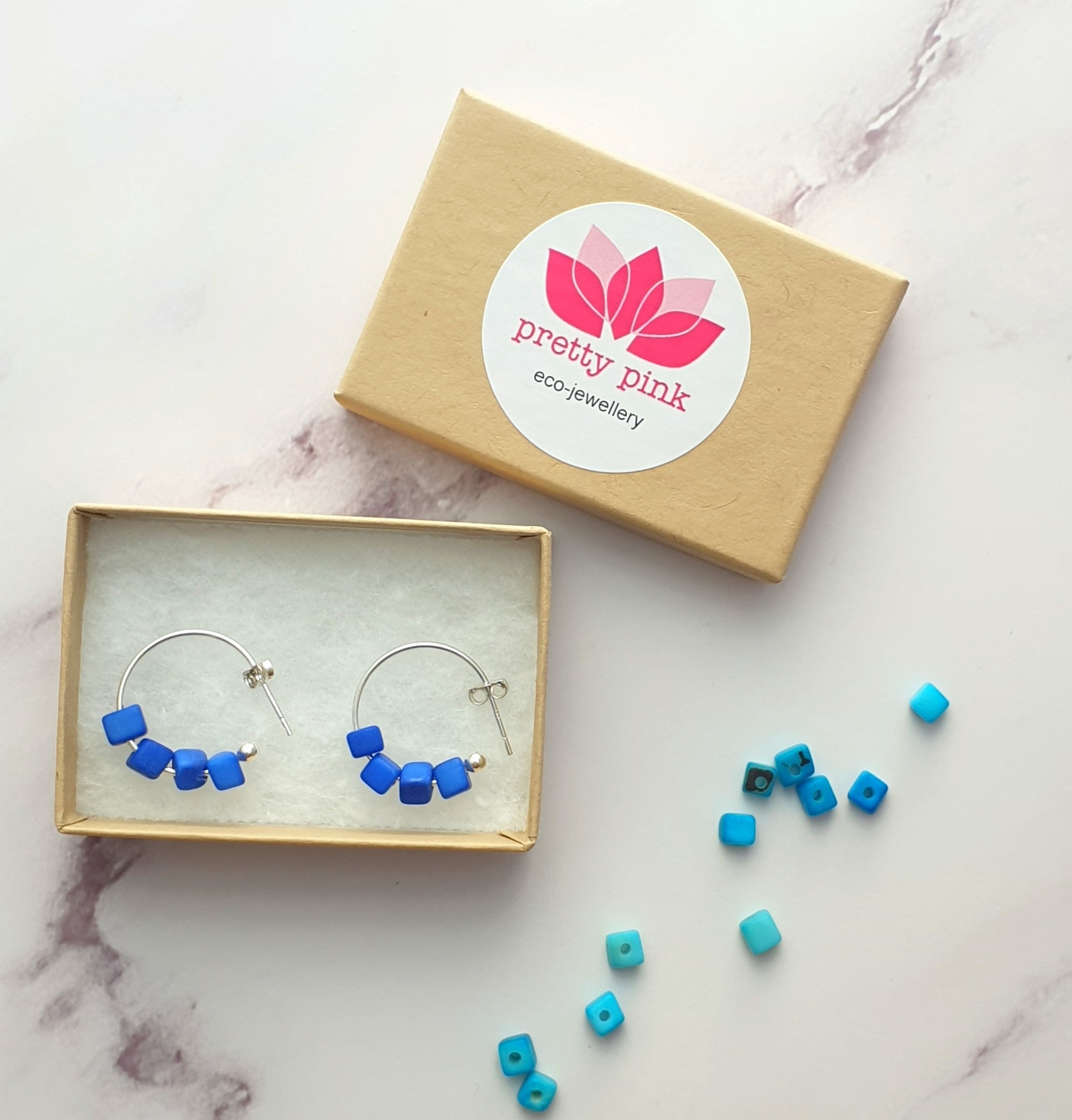 Cubo Mini Silver Hoop Earrings featuring four mini tagua cubes on sterling silver hoops, showcasing a unique and eco-friendly design.