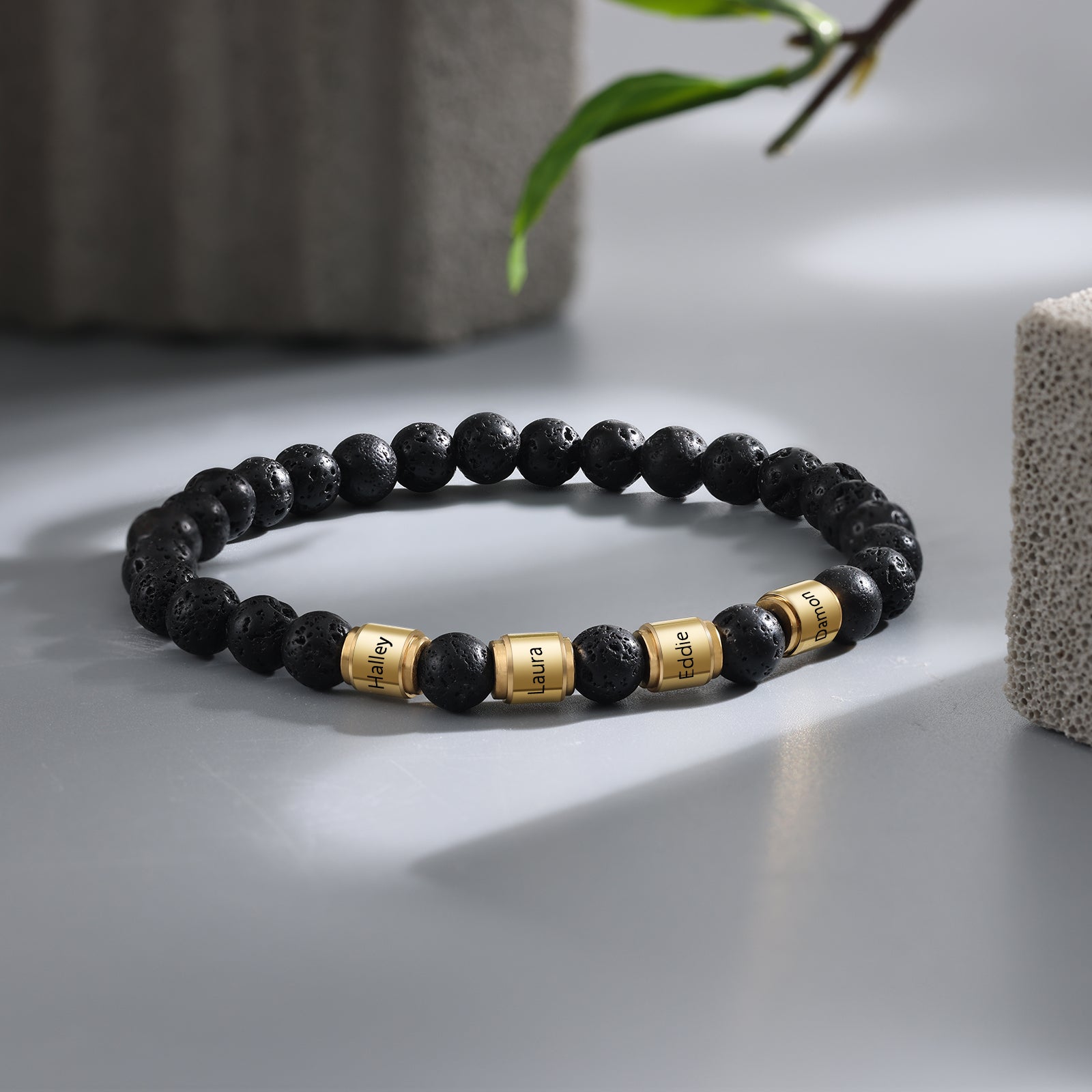 Custom Name Stainless Steel Volcanic Stone Bracelet featuring gold plating and black volcanic stone, personalized with name engraving.