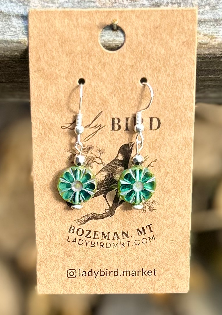 Czech Glass Bronzed Aquamarine Flower Window Coin Earrings featuring translucent aquamarine glass with floral design and metallic accents.