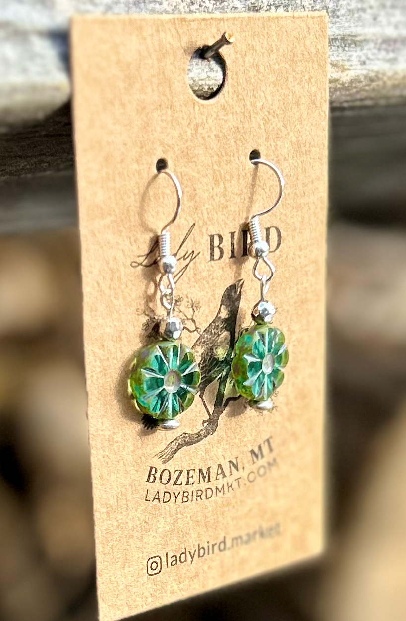 Czech Glass Bronzed Aquamarine Flower Window Coin Earrings featuring translucent aquamarine glass with floral design and metallic accents.