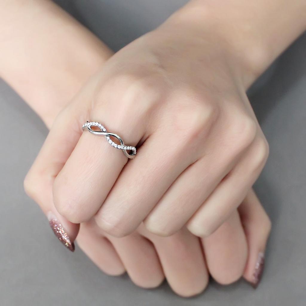 DA243 High Polished Stainless Steel Ring featuring a clear AAA Grade CZ center stone, showcasing its elegant design and shiny finish.