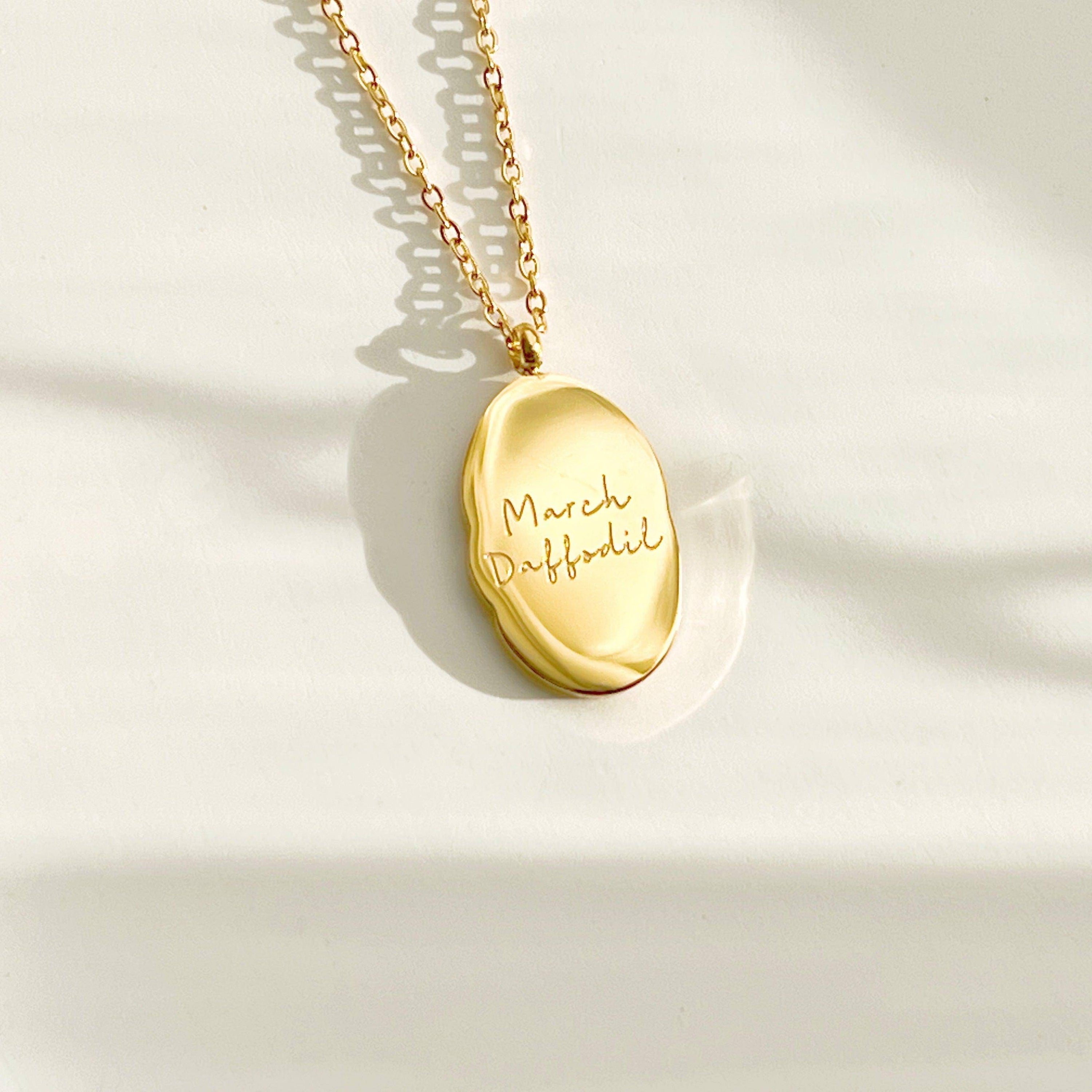 Daffodil Pendant Necklace featuring a gold plated stainless steel charm with a daffodil flower pattern, displayed elegantly on a soft background.