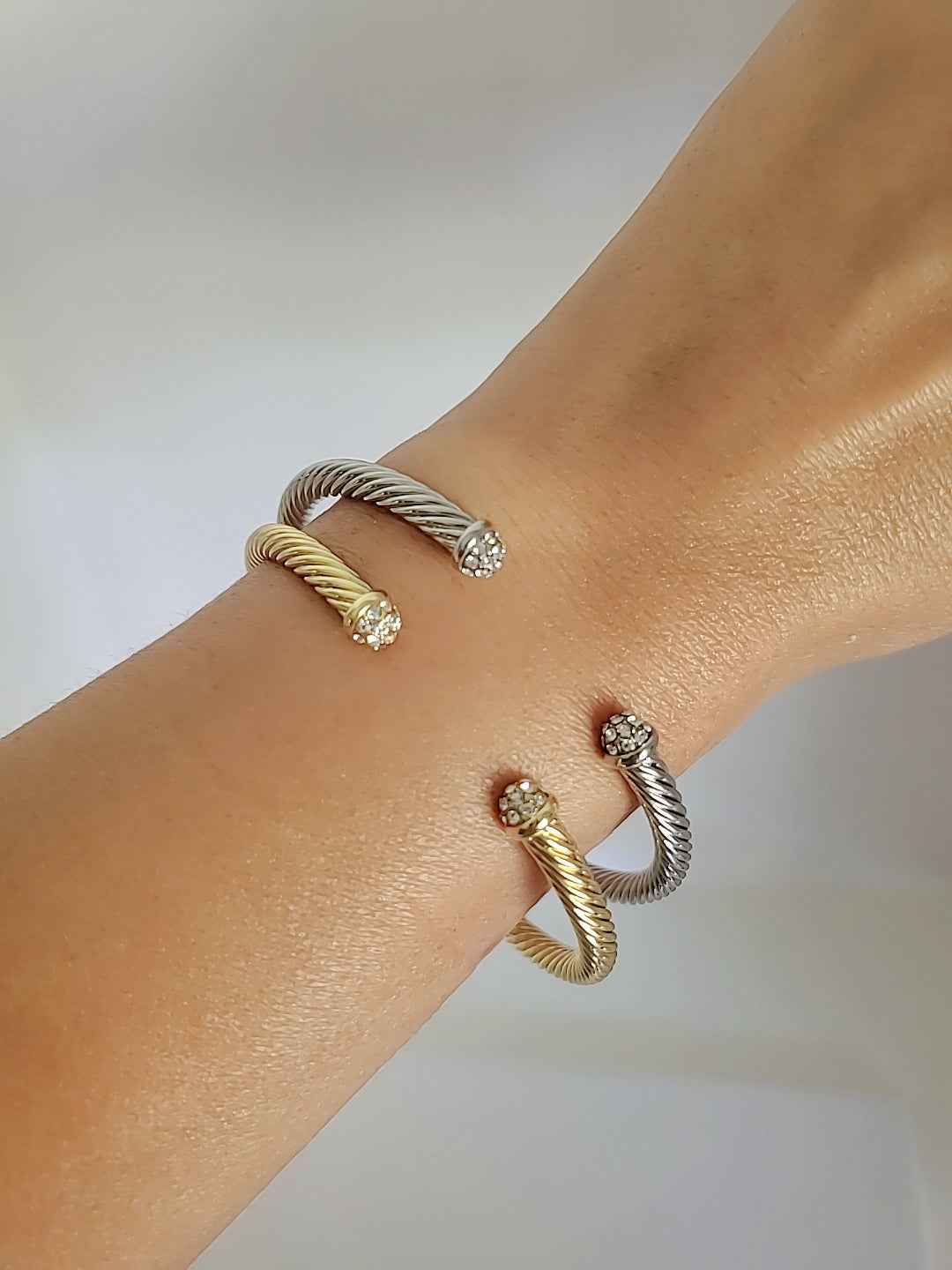 Dainty Crystals Dome Bangle in Gold and Silver with a sleek cable design and dome ends, showcasing its elegant and modern style.