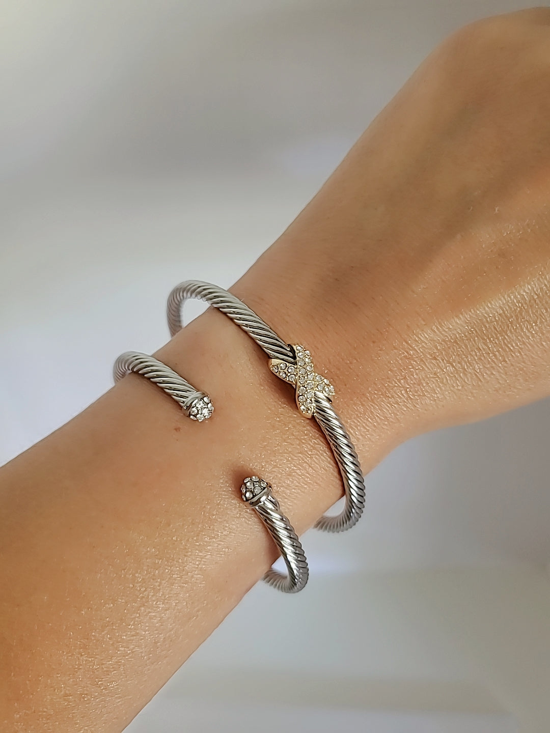 Dainty Crystals Dome Bangle in Gold and Silver with a sleek cable design and dome ends, showcasing its elegant and modern style.