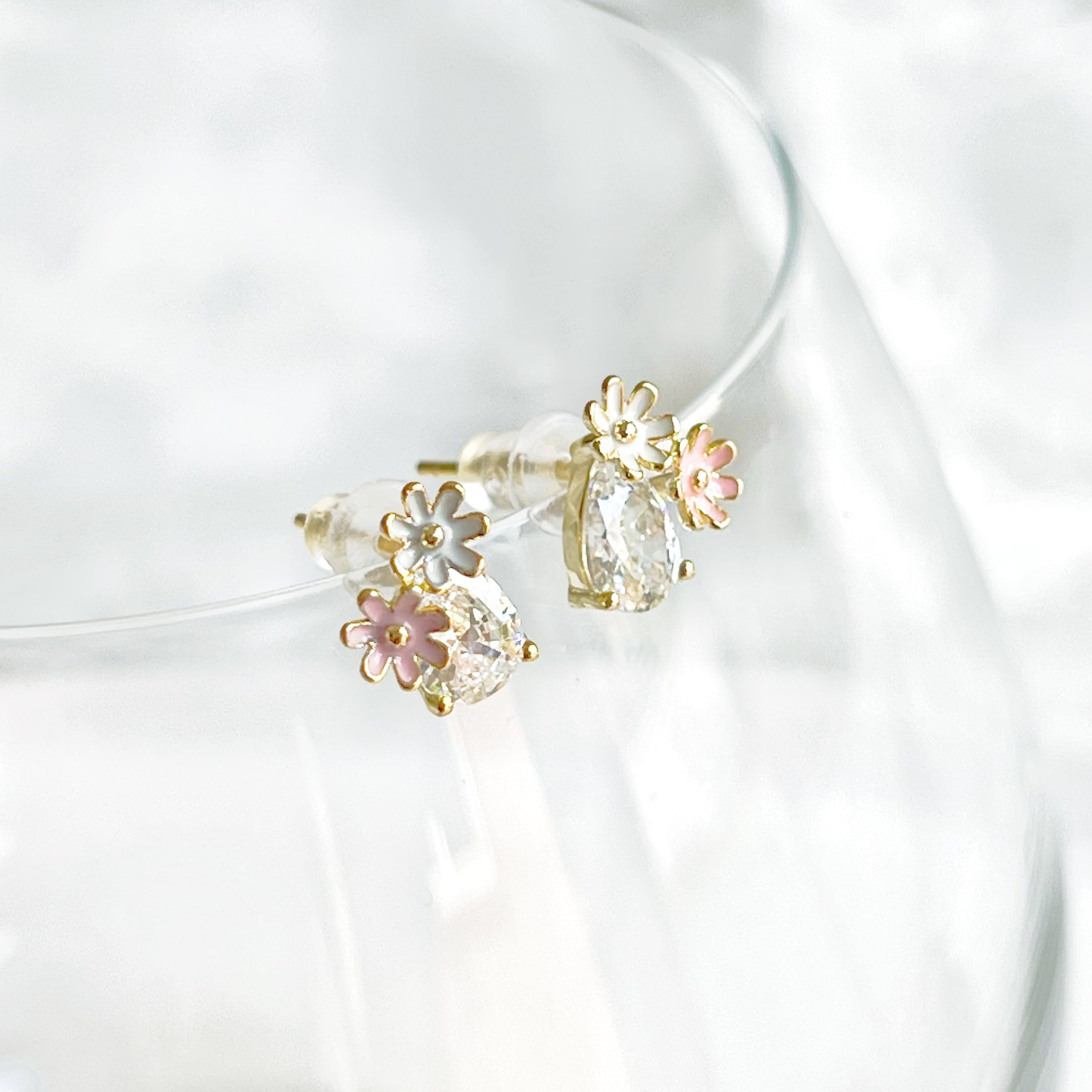 Dainty Daisy Flower Stud Earrings featuring a clear teardrop zircon crystal, crafted from sterling silver and gold plated bronze.