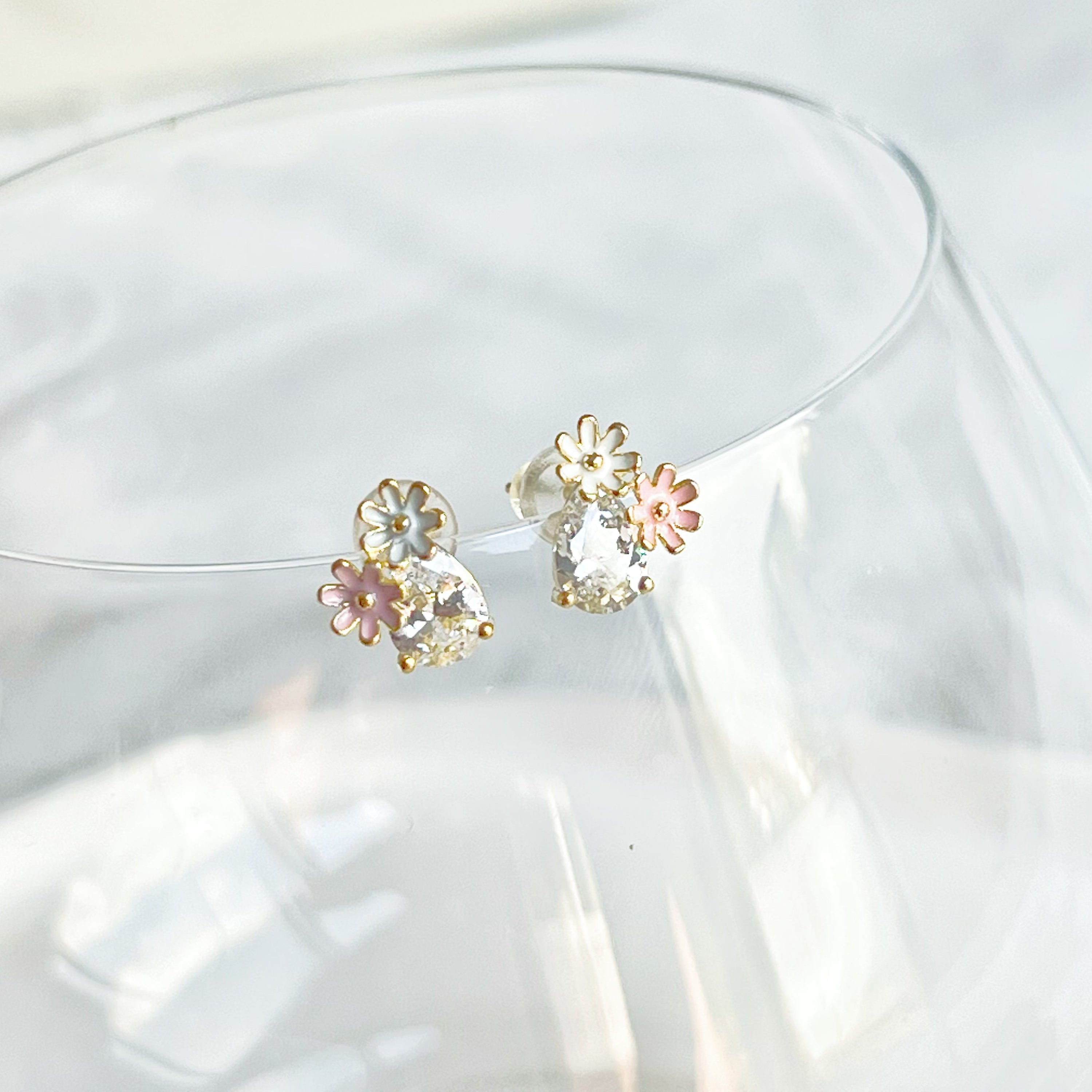 Dainty Daisy Flower Stud Earrings featuring a clear teardrop zircon crystal, crafted from sterling silver and gold plated bronze.