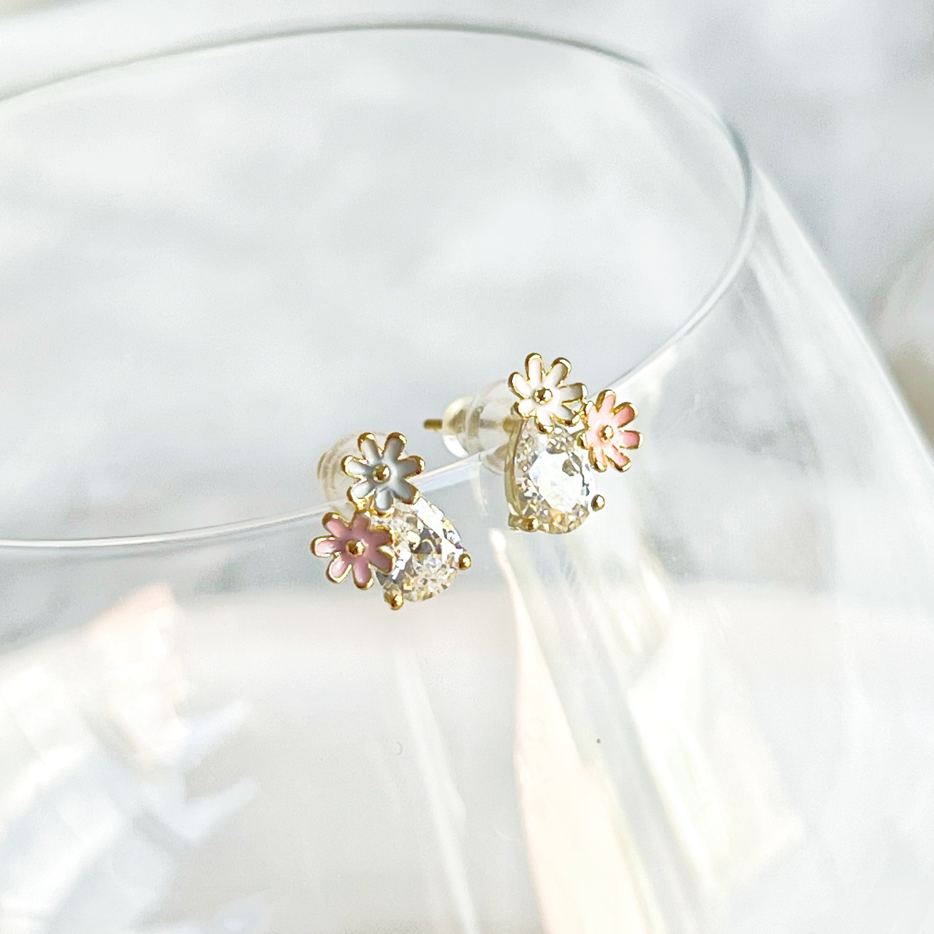 Dainty Daisy Flower Stud Earrings featuring a clear teardrop zircon crystal, crafted from sterling silver and gold plated bronze.