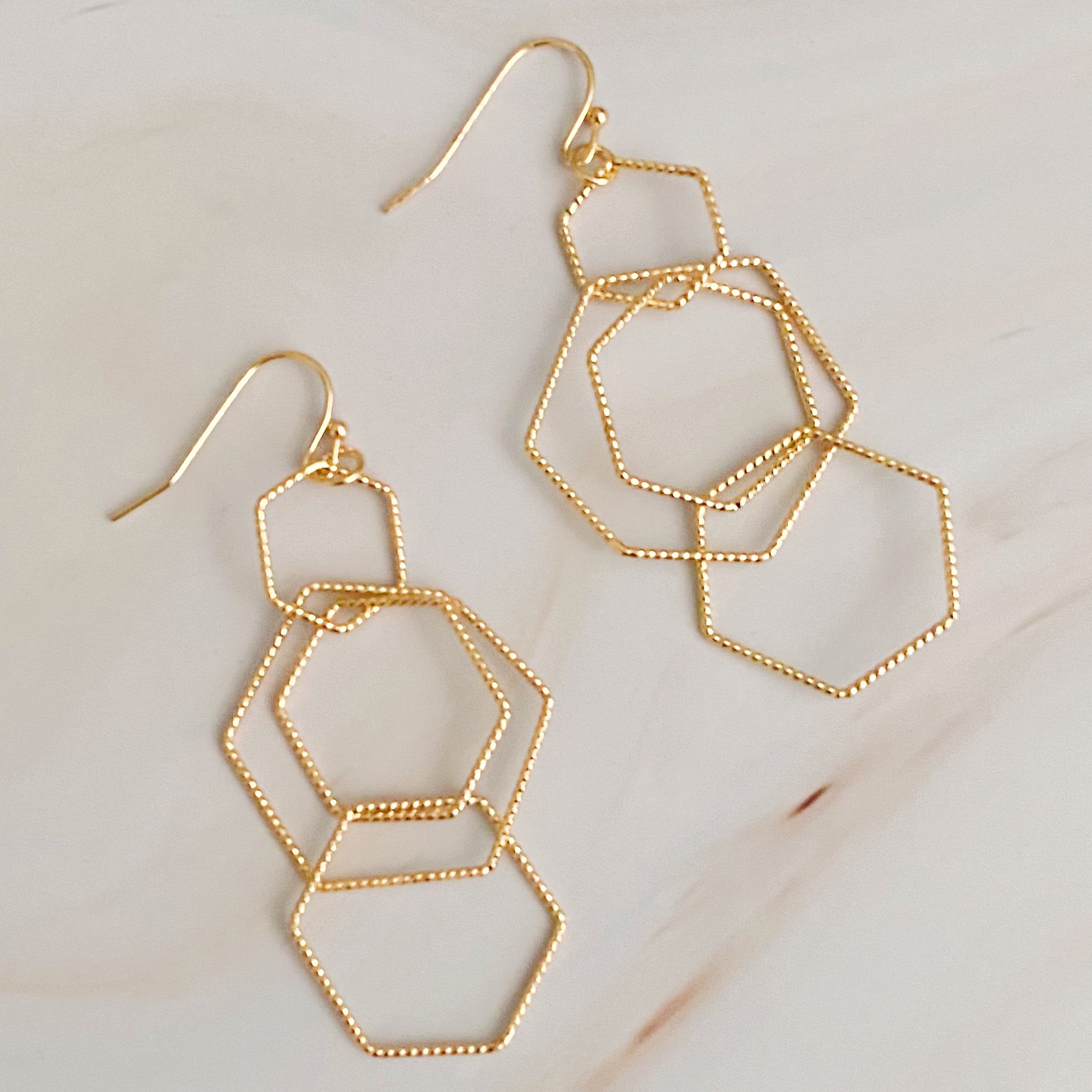 Dainty Dimensional Drop Earrings featuring hexagon designs in gold plated alloy, showcasing a beautiful shine and lightweight construction.