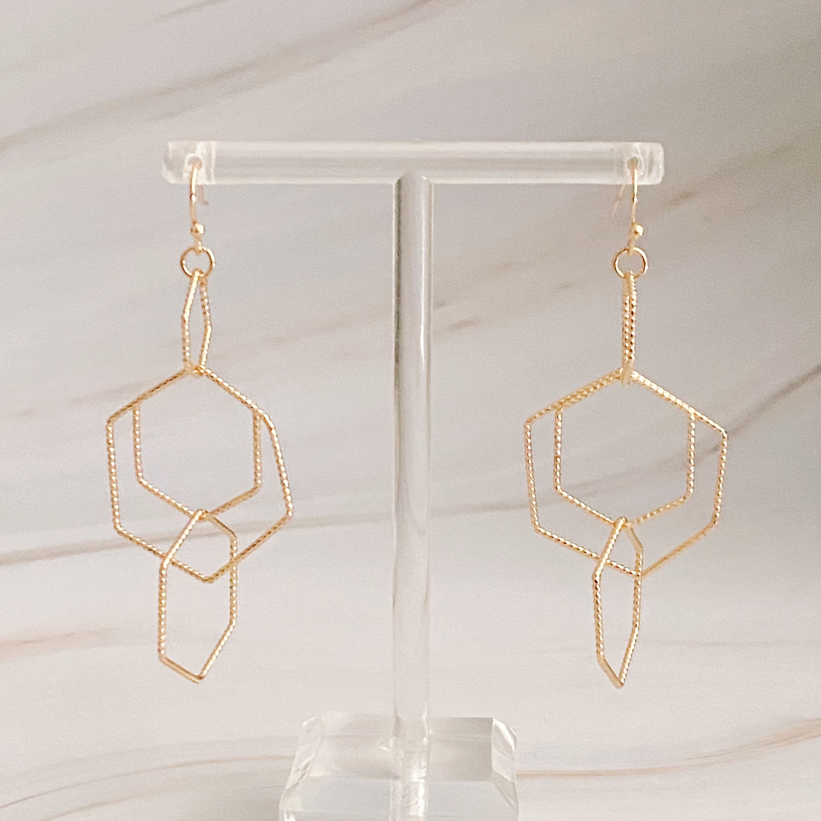 Dainty Dimensional Drop Earrings featuring hexagon designs in gold plated alloy, showcasing a beautiful shine and lightweight construction.