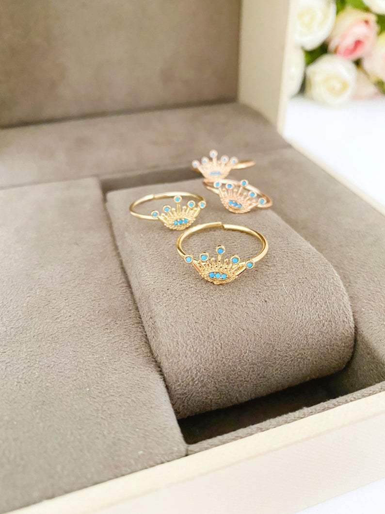 Dainty Evil Eye Ring in rose gold, featuring an adjustable design and a crown evil eye motif, perfect for everyday wear.