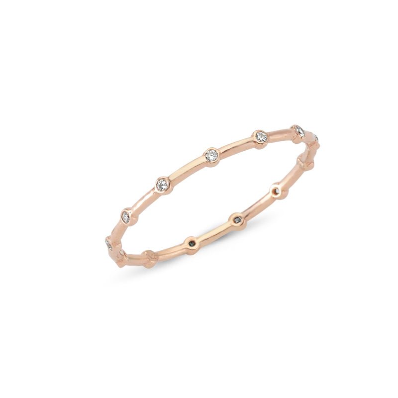 A stack of three dainty silver band rings with clear CZ crystals, showcasing their elegant design and craftsmanship.