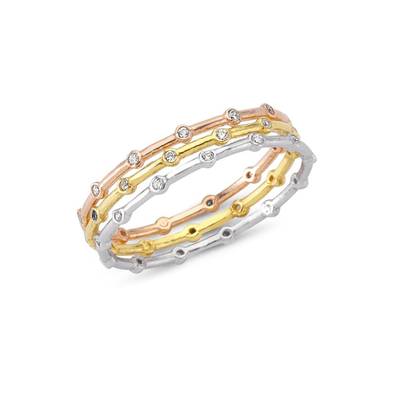A stack of three dainty silver band rings with clear CZ crystals, showcasing their elegant design and craftsmanship.