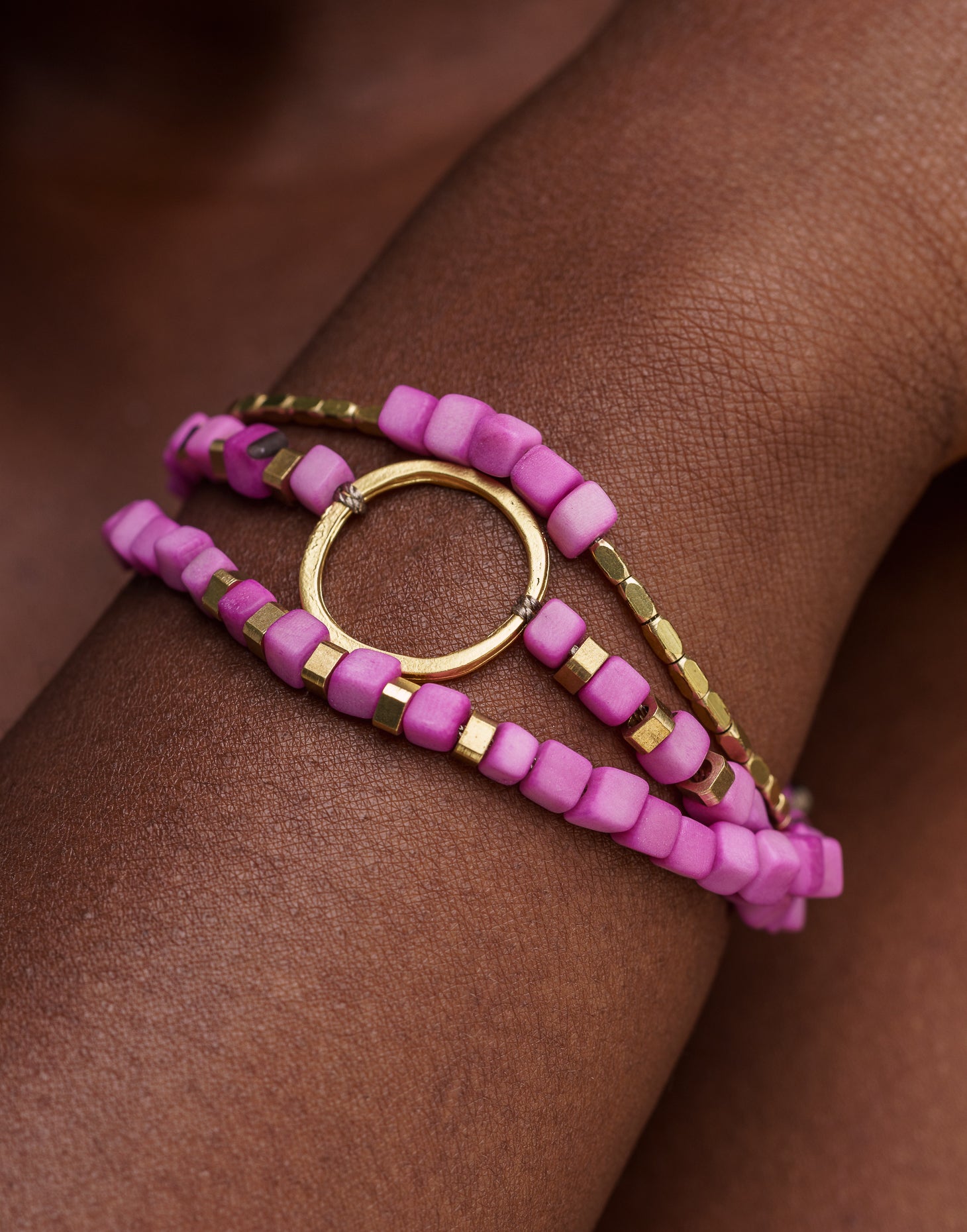 Dainty Triple Tagua Bracelet in pink, featuring delicate tagua nut squares and brass accents, elegantly displayed.
