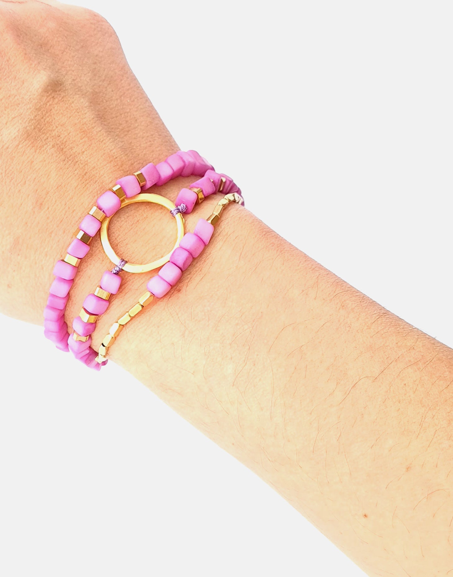 Dainty Triple Tagua Bracelet in pink, featuring delicate tagua nut squares and brass accents, elegantly displayed.