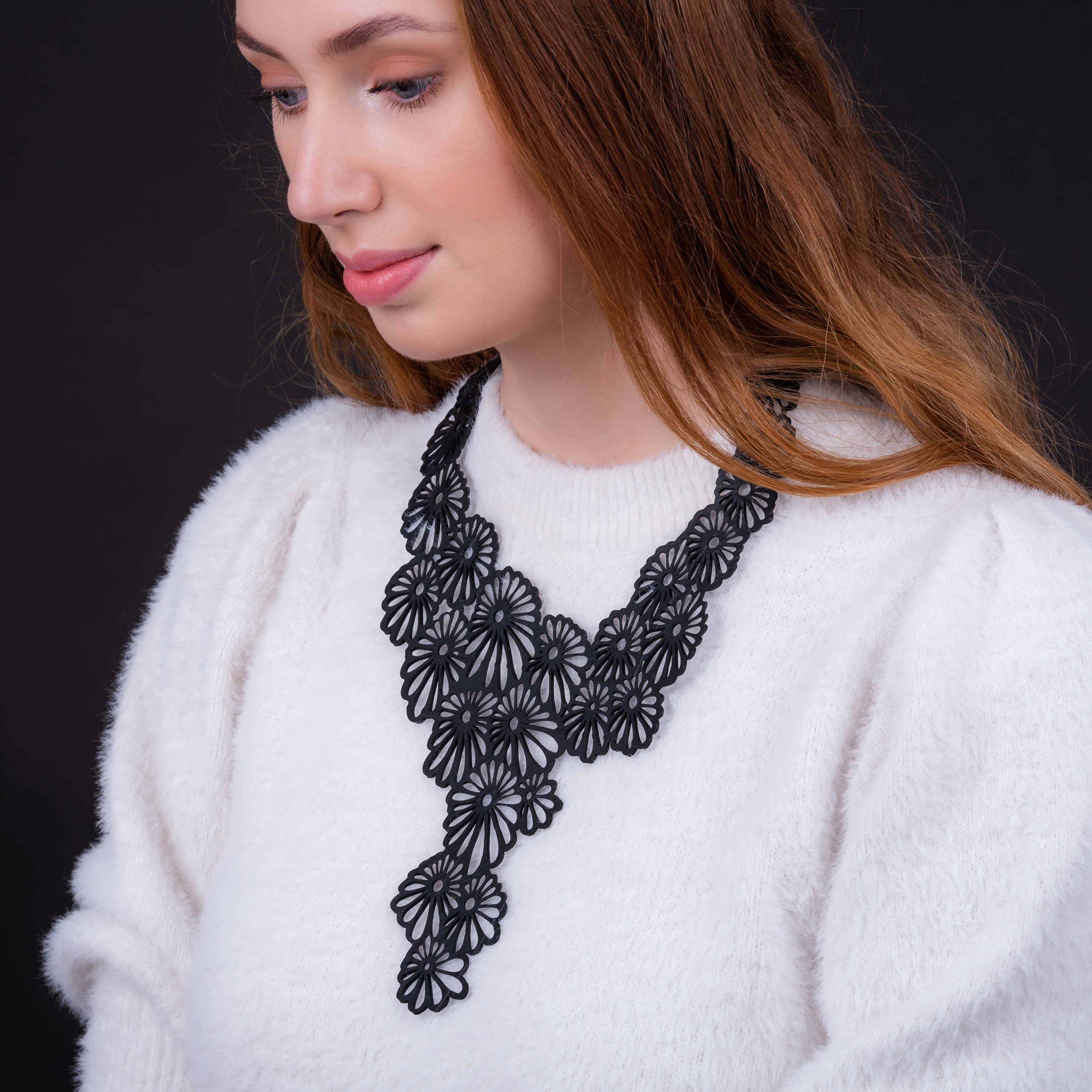 Daisy Statement Inner Tube Necklace made from reclaimed rubber, featuring a unique floral design and durable cord.