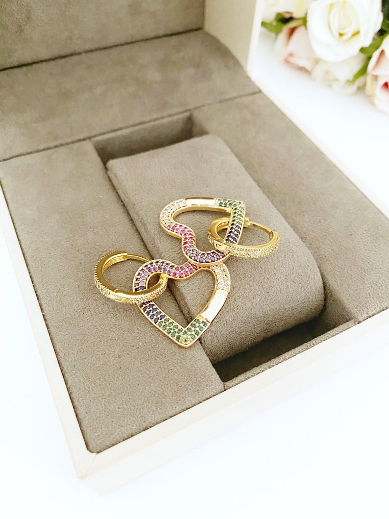 A pair of handmade dangle earrings featuring rainbow zircon stones with heart and star charms, elegantly designed in gold color.