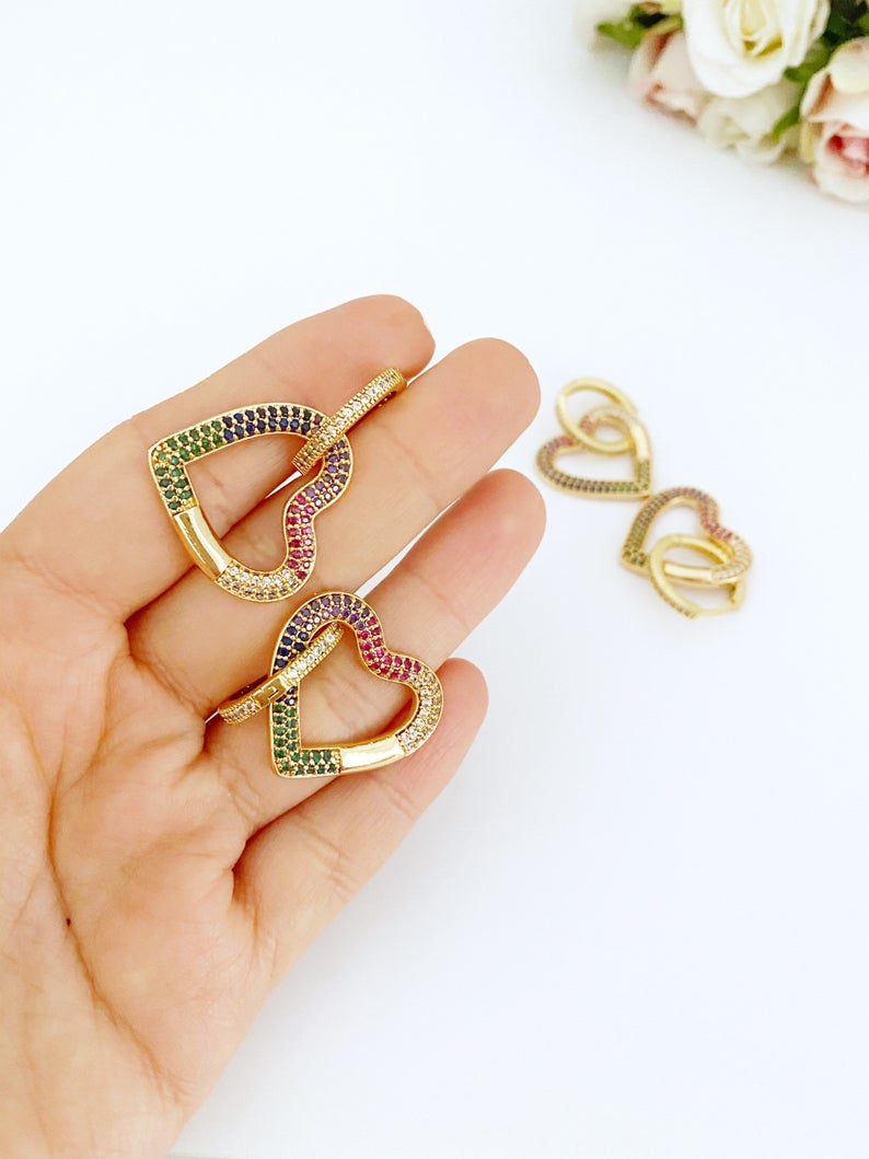 A pair of handmade dangle earrings featuring rainbow zircon stones with heart and star charms, elegantly designed in gold color.