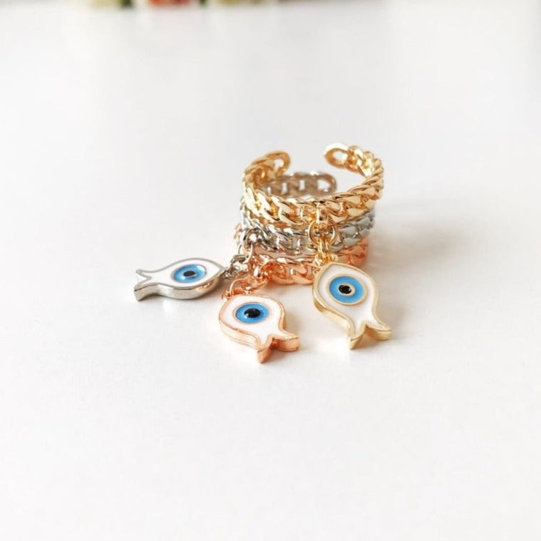 Dangle Fish Evil Eye Ring featuring a fish charm and evil eye design in silver, gold, and rose gold finishes.