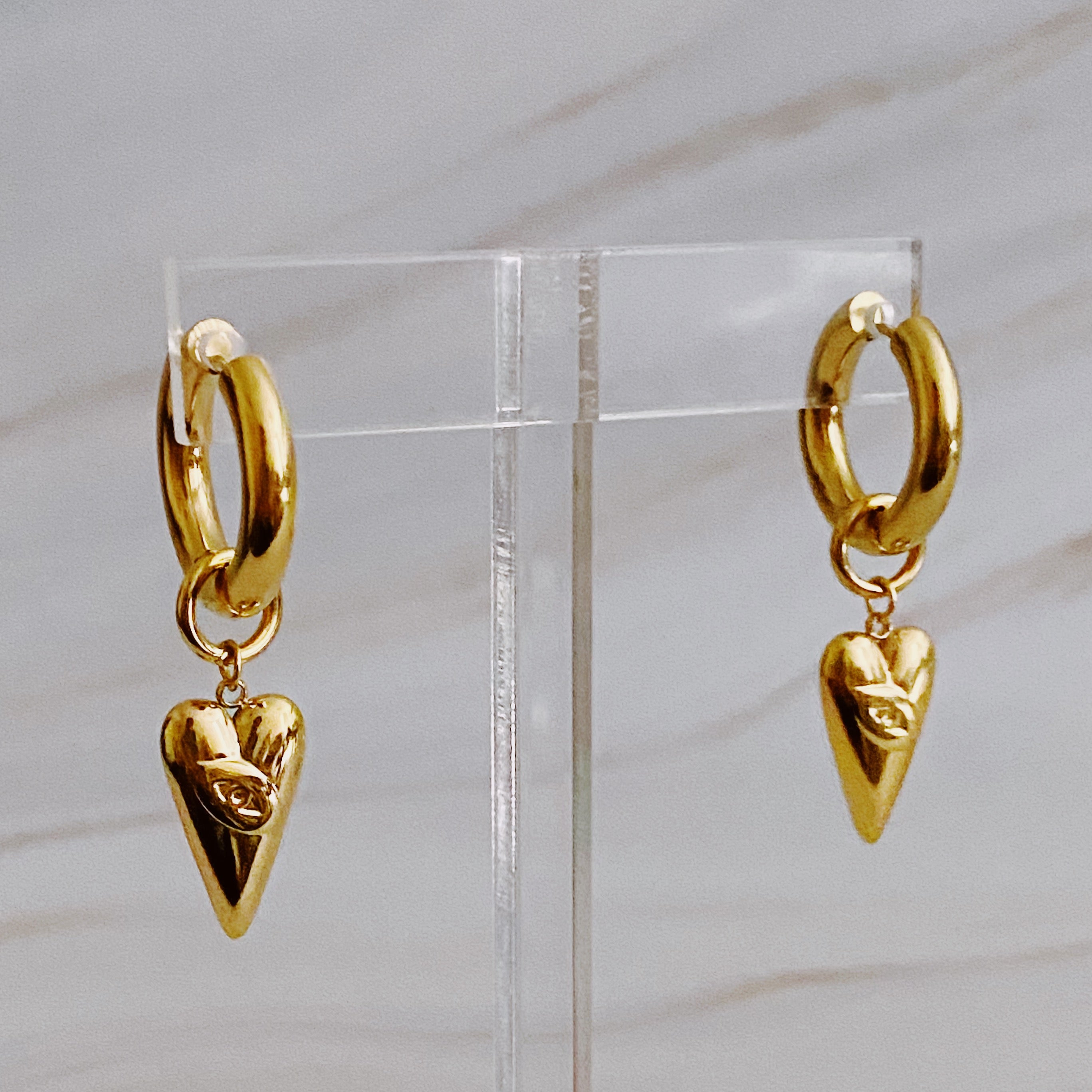 Elegant Dangle Heart Drop Earrings in 18k gold plated stainless steel with intricate design.