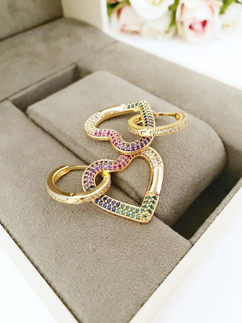 A pair of handmade gold dangle heart earrings featuring rainbow zircon, perfect for Valentine's Day and weddings.