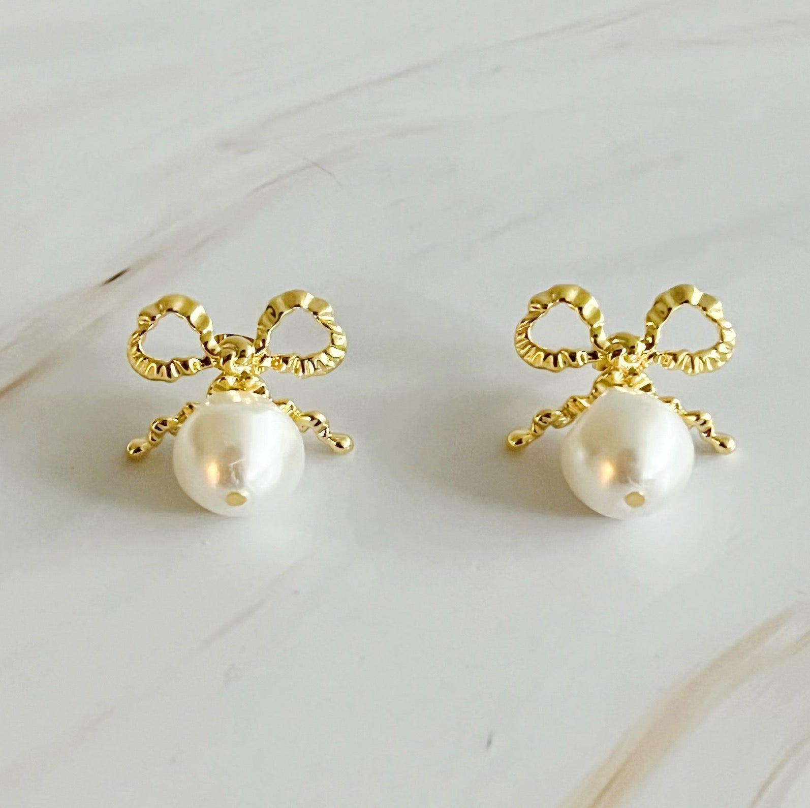 Elegant Dangle Pearl Antique Bow Earrings featuring a crinkled antique bow and a dangling glass pearl, perfect for sophisticated styling.