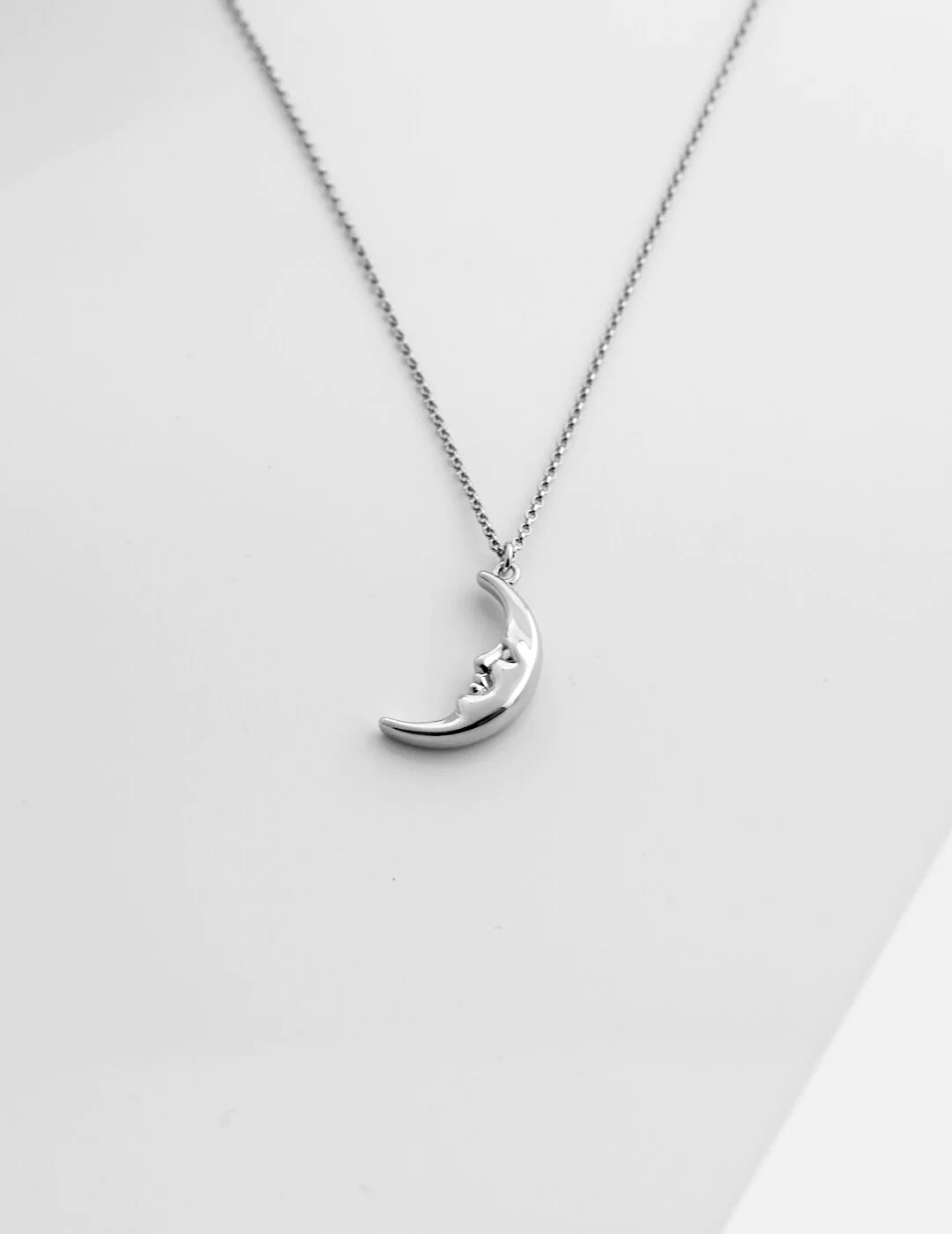 Delicate Crescent Moon Pendant Necklace made of sterling silver with gold vermeil plating, showcasing its elegant crescent moon design.