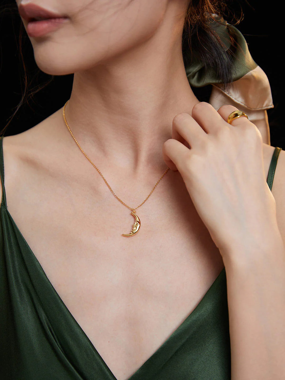 Delicate Crescent Moon Pendant Necklace made of sterling silver with gold vermeil plating, showcasing its elegant crescent moon design.