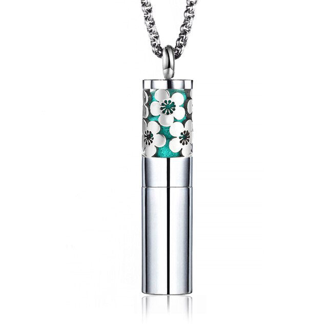 A stylish silver designer floral perfume essential oil locket bottle necklace with adjustable length and assorted colored padding.
