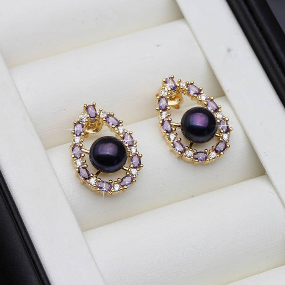 Designer oval earrings featuring genuine freshwater pearls and purple simulated diamonds, showcasing elegance and style.