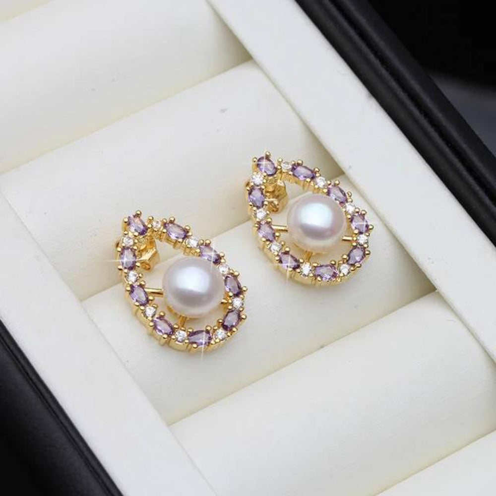 Designer oval earrings featuring genuine freshwater pearls and purple simulated diamonds, showcasing elegance and style.