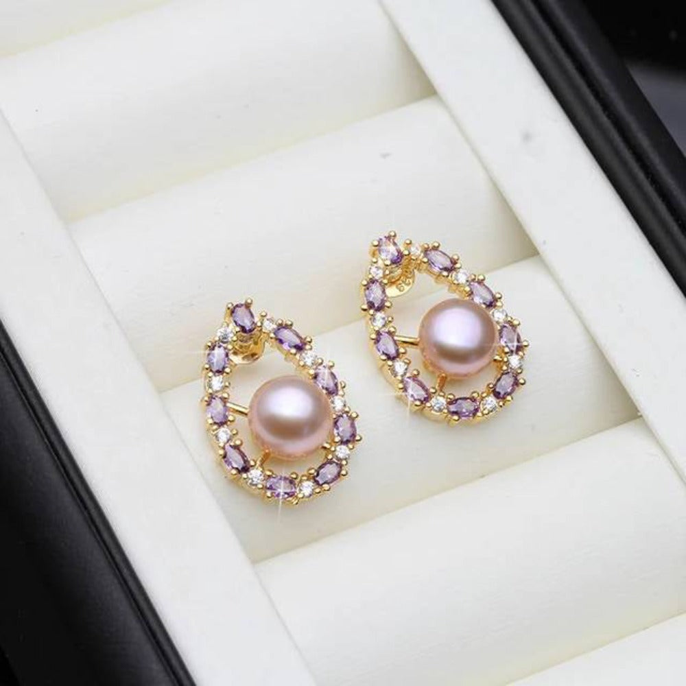 Designer oval earrings featuring genuine freshwater pearls and purple simulated diamonds, showcasing elegance and style.