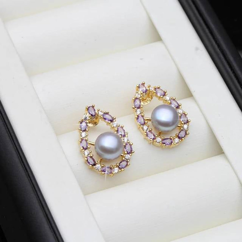 Designer oval earrings featuring genuine freshwater pearls and purple simulated diamonds, showcasing elegance and style.