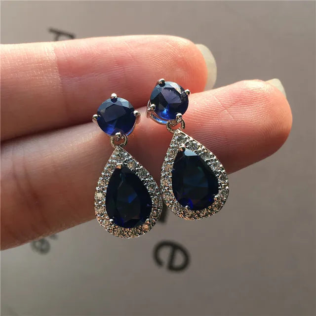 Elegant Designer Simulated Diamond Blue Teardrop Earrings showcasing a clear and blue color combination, perfect for any occasion.