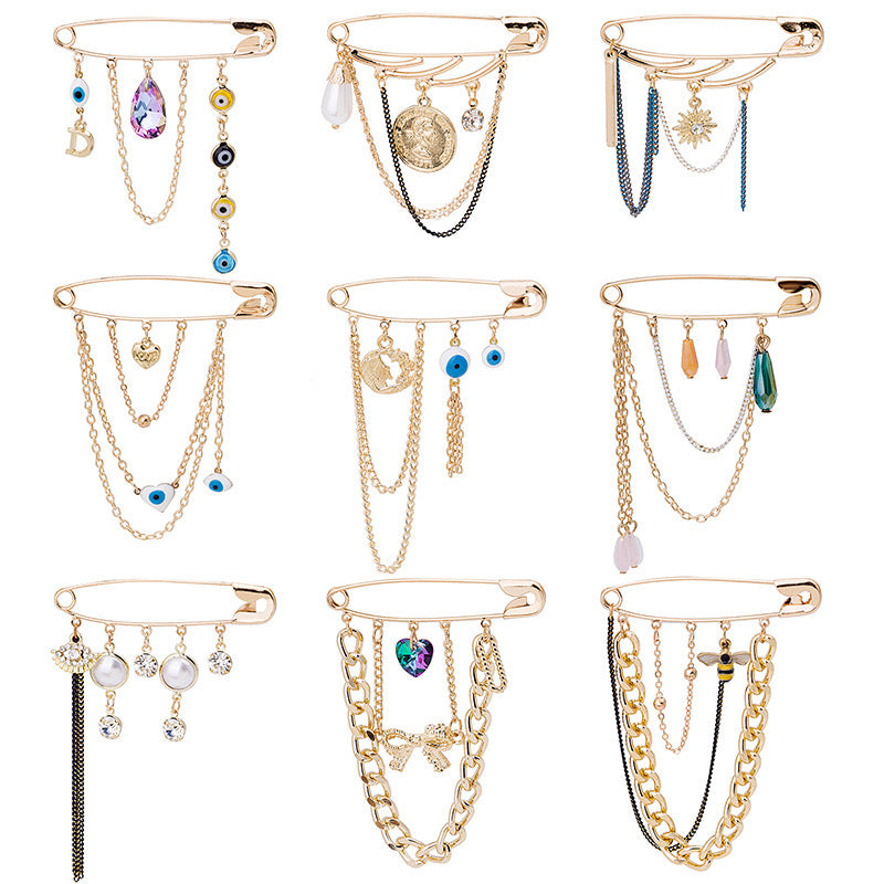 A stylish brooch featuring a devil eye design with water drop accents and tassels, made from durable alloy.