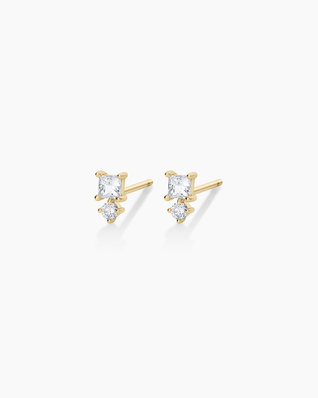 Elegant Diamond and White Sapphire Studs featuring a central diamond surrounded by sparkling white sapphires, showcasing luxury and sophistication.
