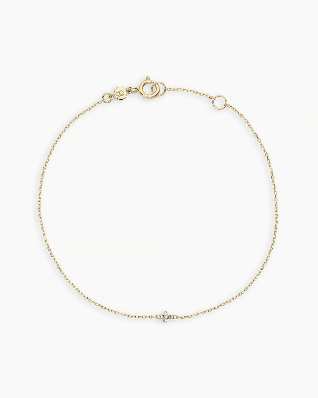 A delicate Diamond Cross Bracelet featuring a small cross charm adorned with lab-grown diamonds, adjustable length, and spring ring closure.