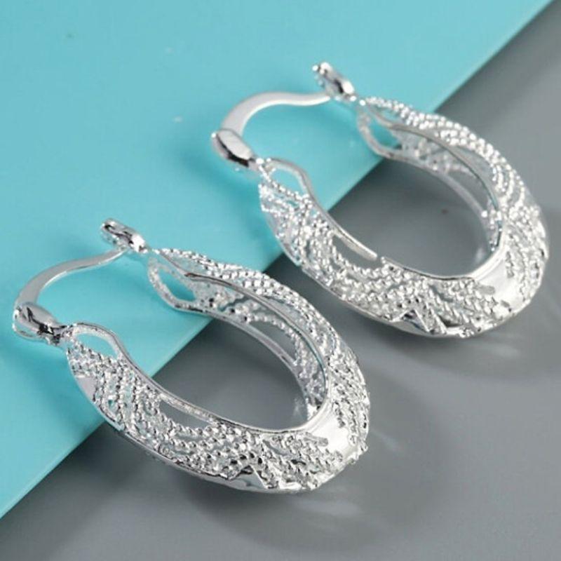 A pair of elegant Diamond Cut Fancy Filigree Hoop Earrings made from sterling silver over brass, showcasing intricate filigree design.