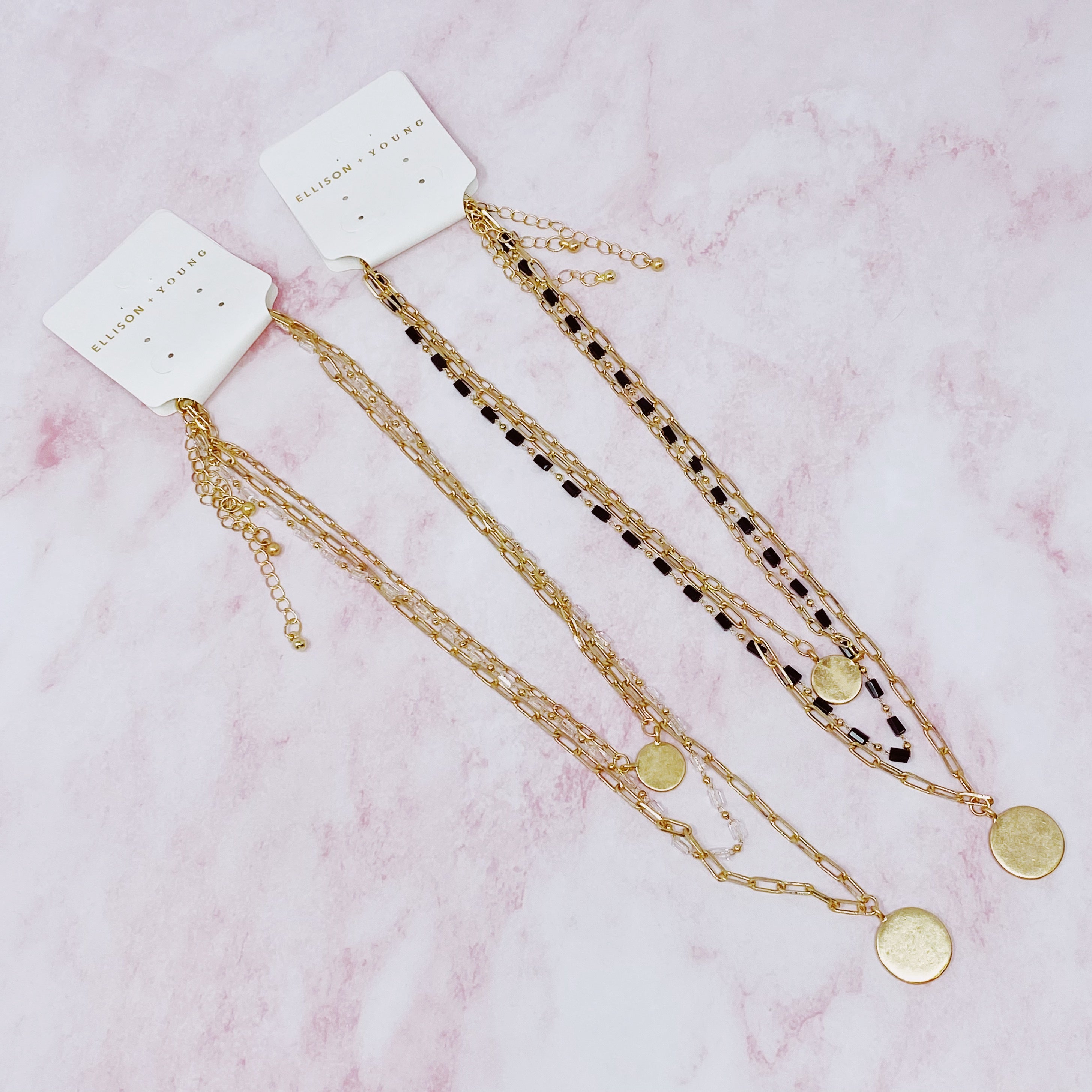 A stylish set of three necklaces featuring disc pendants and beaded designs, perfect for layering and versatile fashion.