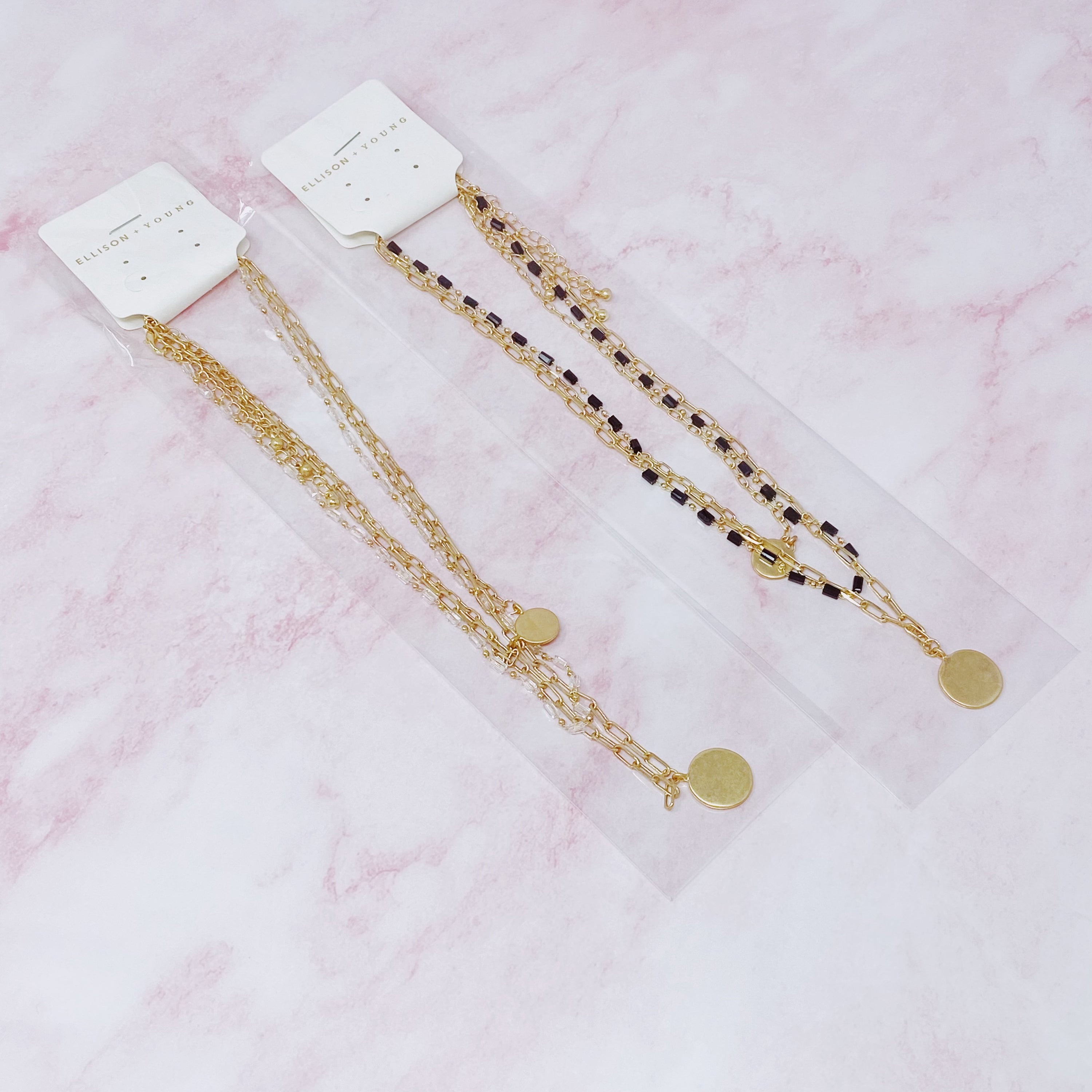 A stylish set of three necklaces featuring disc pendants and beaded designs, perfect for layering and versatile fashion.