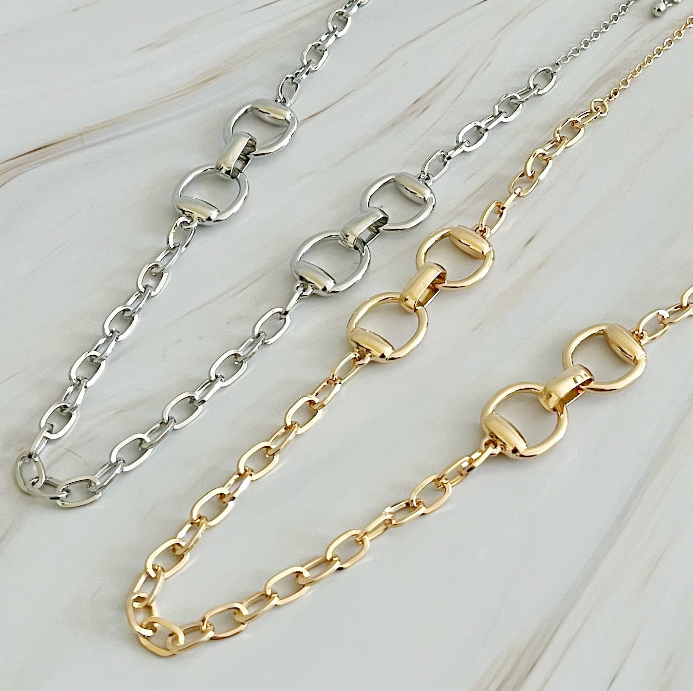 Double Equestrian Chain Necklace featuring interlocking chains in a chic design, perfect for stylish accessorizing.
