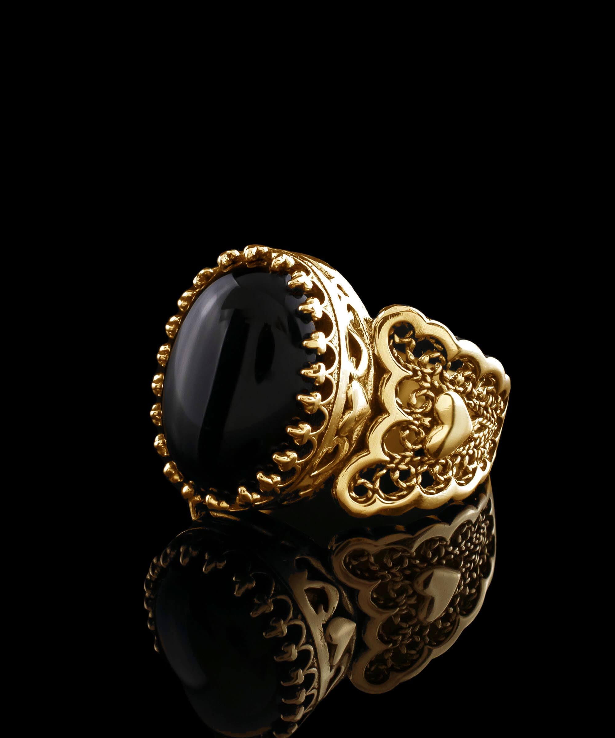 Elegant gold plated ring featuring double heart design with black onyx gemstone, beautifully crafted in filigree art style.