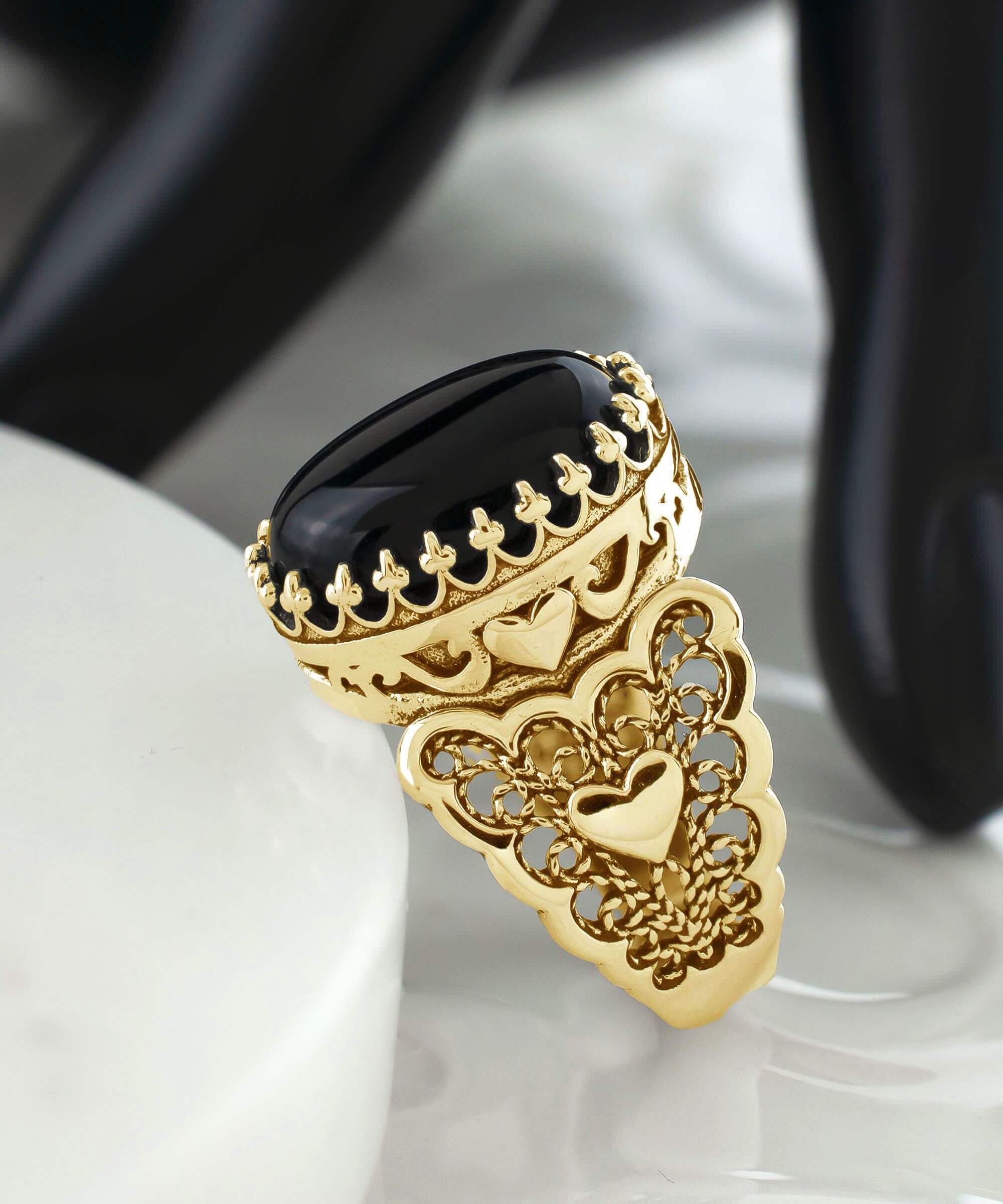 Elegant gold plated ring featuring double heart design with black onyx gemstone, beautifully crafted in filigree art style.