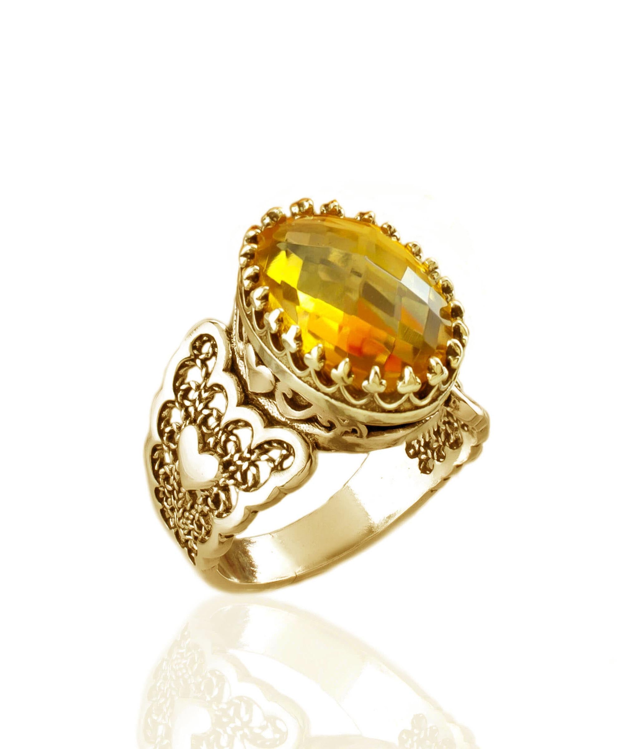 A beautiful gold plated ring featuring a double heart design with citrine gemstones, showcasing intricate filigree art.