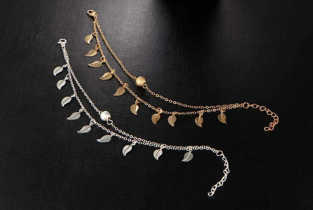 A stylish double layer feather anklet made of high-quality zinc alloy, featuring delicate feather accents and an adjustable length.