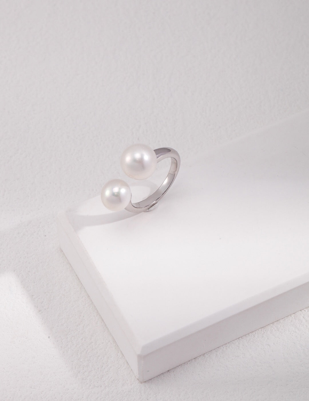 Elegant Double Pearl Open Ring featuring freshwater pearls on an adjustable sterling silver band, perfect for any occasion.