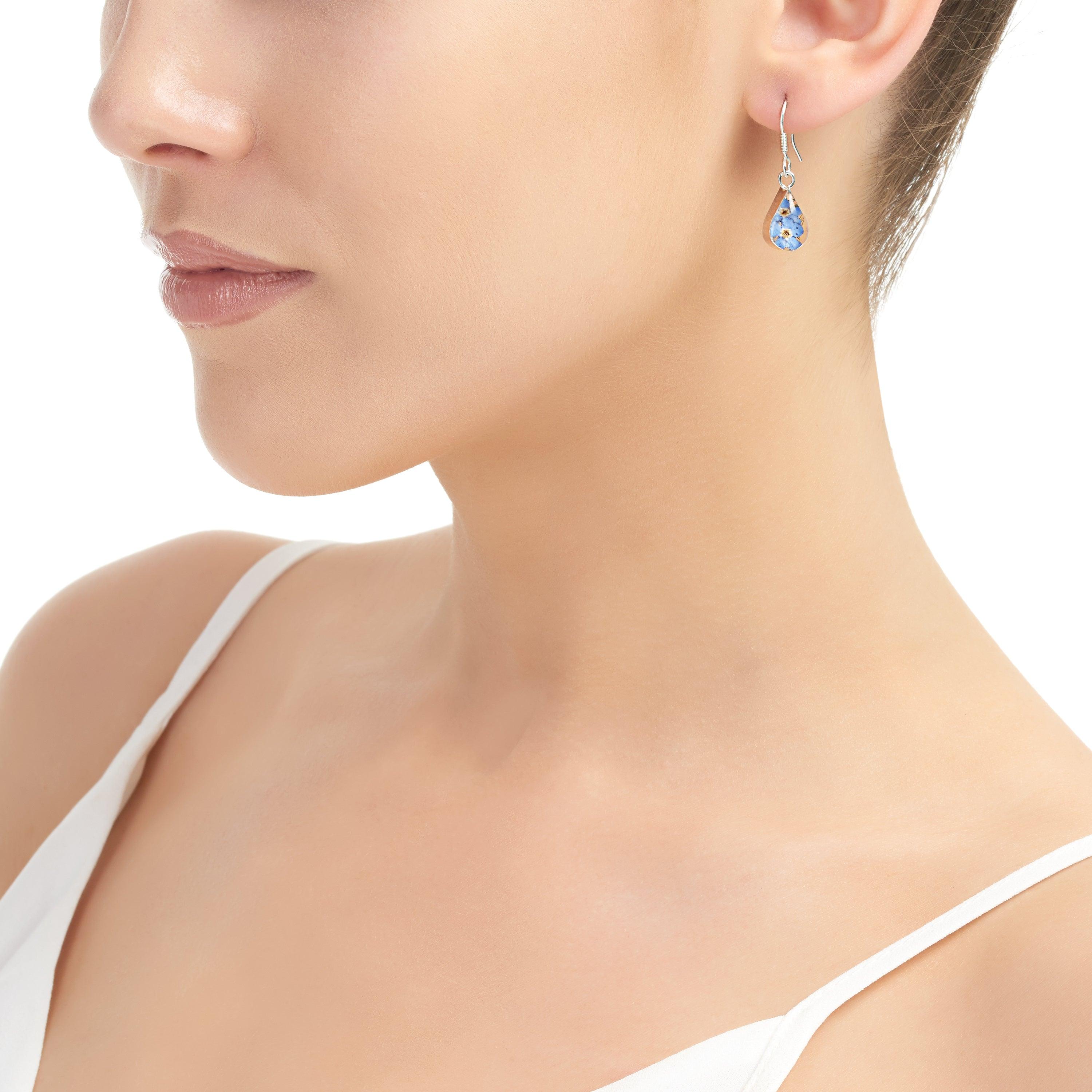 Handmade sterling silver drop dangle earrings featuring real forget-me-not flowers preserved in resin, elegantly presented in a gift box.