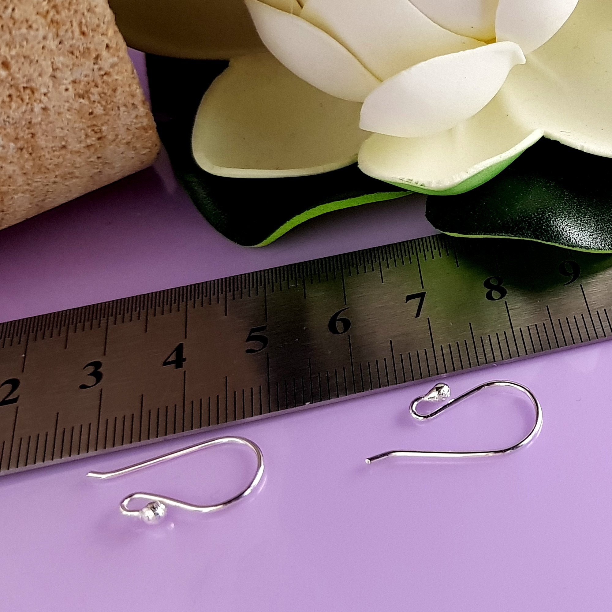 A pack of 10 pairs of handmade sterling silver earring hooks, showcasing their polished finish and 2.3 mm ball design for easy earring attachment.