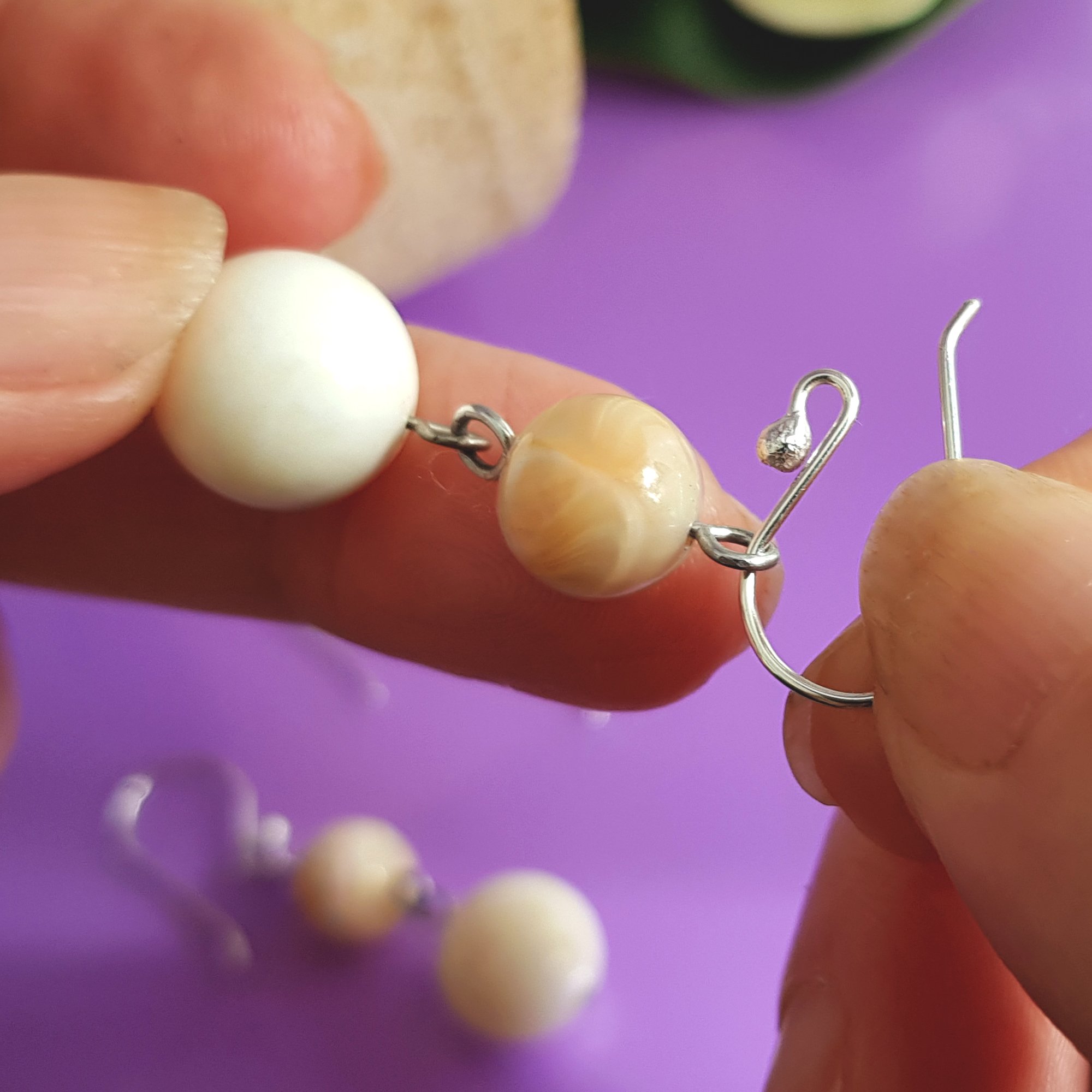 A pack of 10 pairs of handmade sterling silver earring hooks, showcasing their polished finish and 2.3 mm ball design for easy earring attachment.