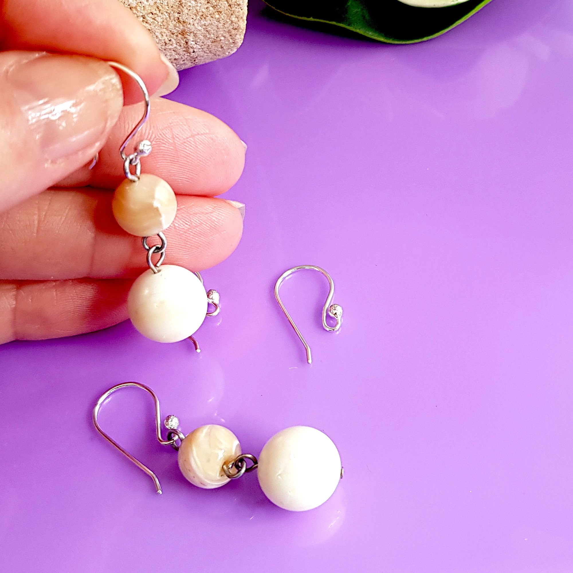 A pack of 10 pairs of handmade sterling silver earring hooks, showcasing their polished finish and 2.3 mm ball design for easy earring attachment.