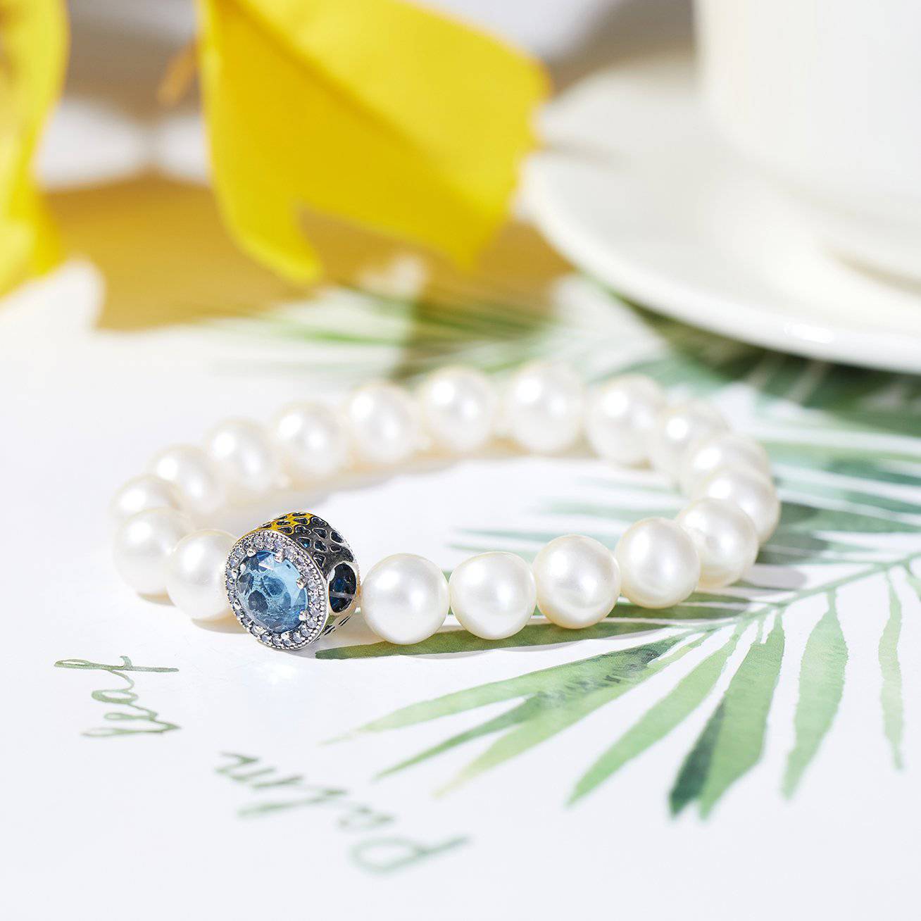 Elegant Freshwater Pearl Bracelet WB00039 featuring white pearls and sapphire blue cubic zirconia, set in gold-plated sterling silver.